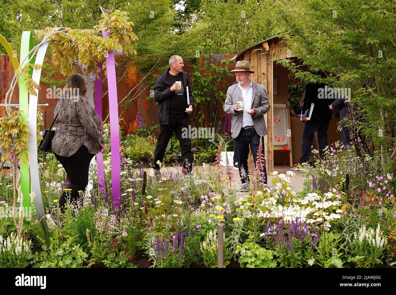 Judges take a close look at one of the gardens on display during a