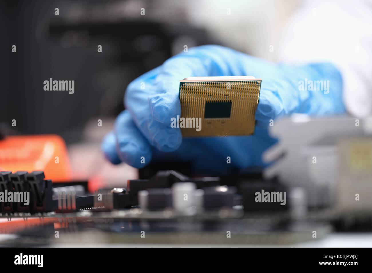 Engineer holds in hands powerful processor or board after repair Stock Photo
