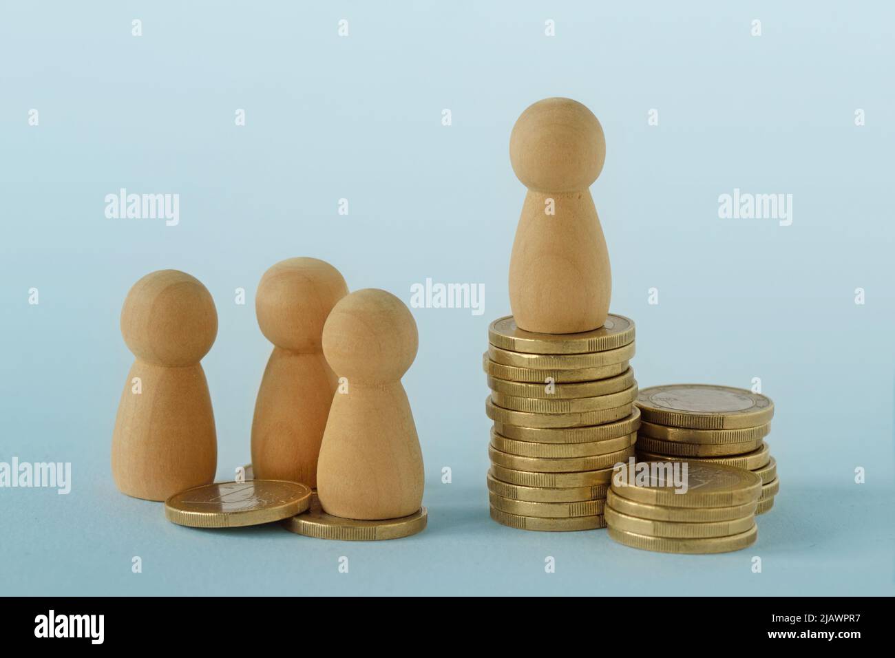 Pawns with stacks of coins - Concept of social and economic inequality Stock Photo
