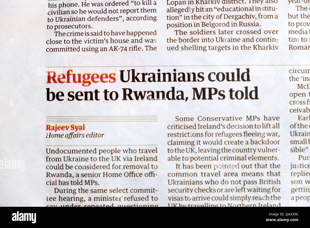 Ukraine 'Refugees Ukrainians could be sent to Rwanda, MPs told Guardian newspaper headline recycling article clipping May 2022 London England UK Stock Photo