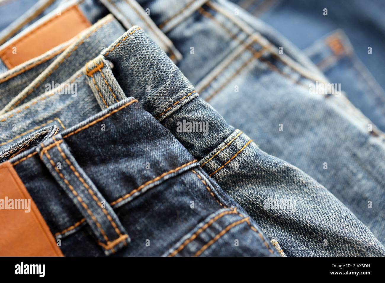 Many jeans in stack in wardrobe room. Row of pants denim jeans in closet.  Concept of buy, sell, shopping and fashionable modern clothes Stock Photo -  Alamy
