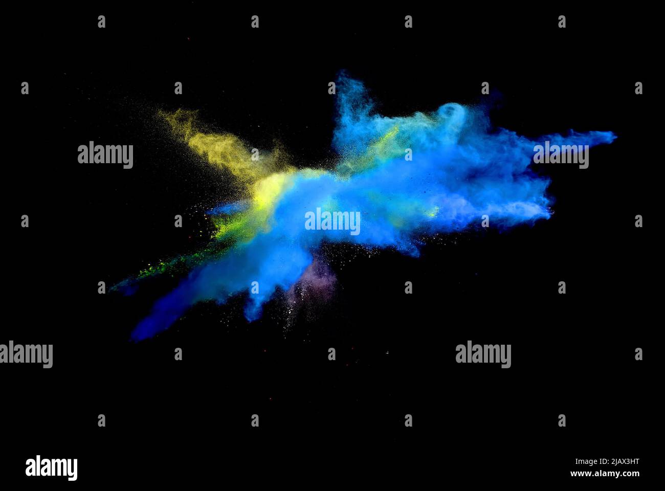 Various multicolored forms of powder paint explode in front of a black ...