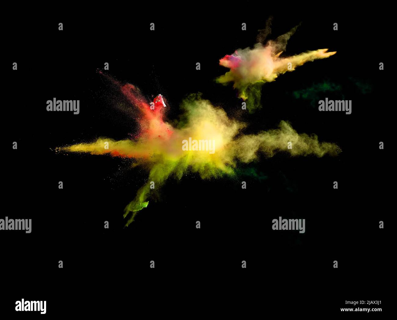 Various multicolored forms of powder paint explode in front of a black ...