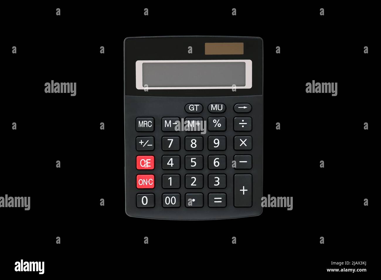 Big black rectangular calculator with solar panel and two red buttons isolated on black background Stock Photo