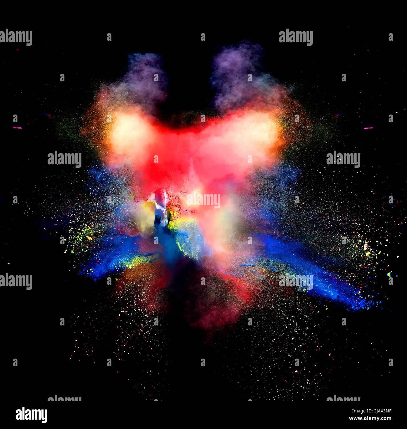Various multicolored forms of powder paint explode in front of a black ...