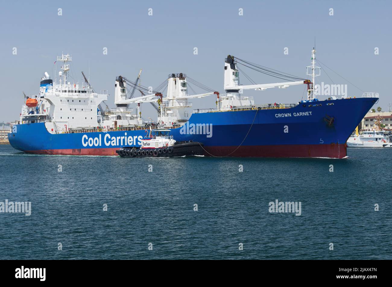 Port of Los Angeles, California, USA - April 27, 2022: image of refrigerated cargo ship Crown Garnet in transit on a sunny day with blue sky. Stock Photo