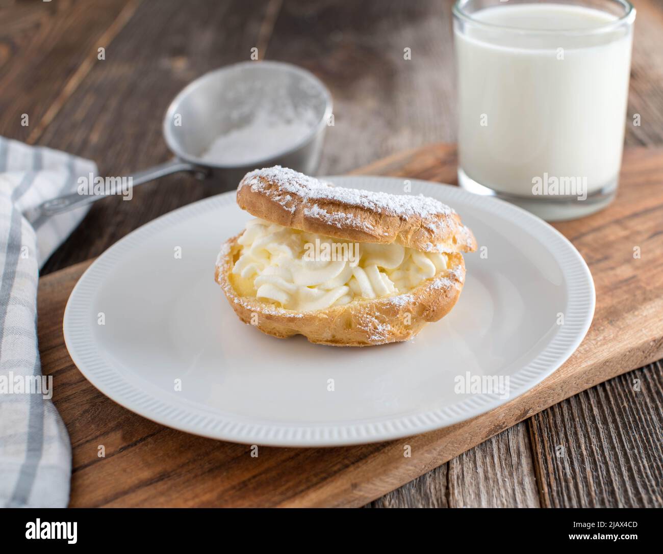 Glass of milk with a piece of pastry Stock Photo