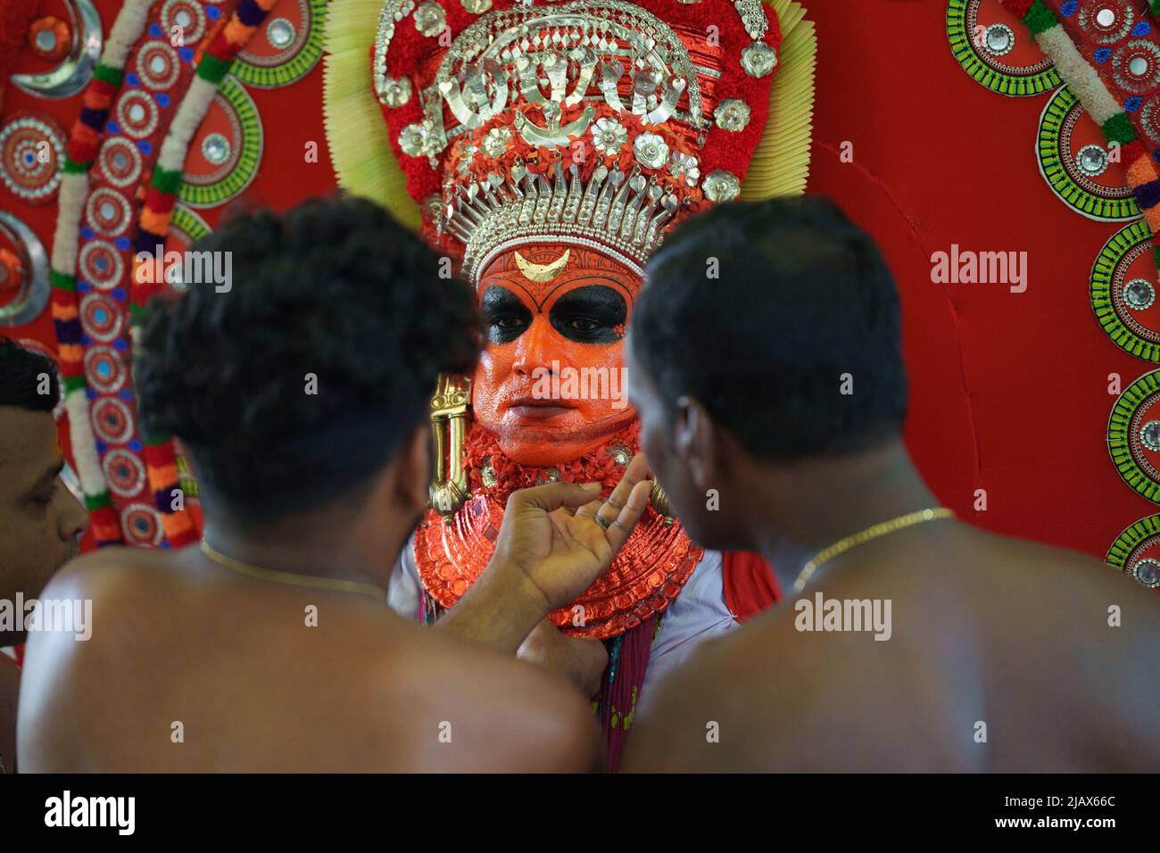 Theyyam is a famous ritual art form in kerala with face painted using organic colors and use musical instruments as Chenda, Elathalam, Kurumkuzal Stock Photo