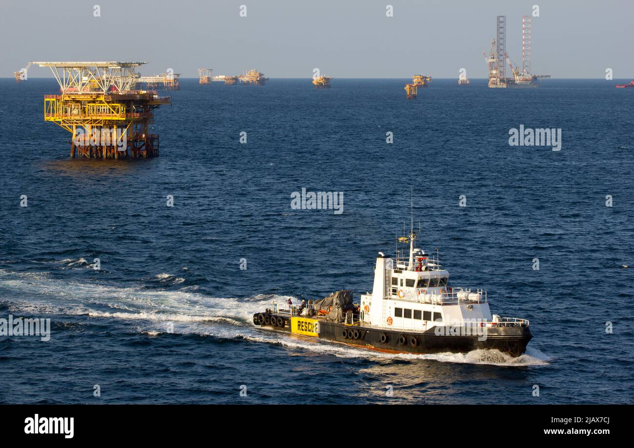 Oil rigs with supply boat boat for transporting people or materials to