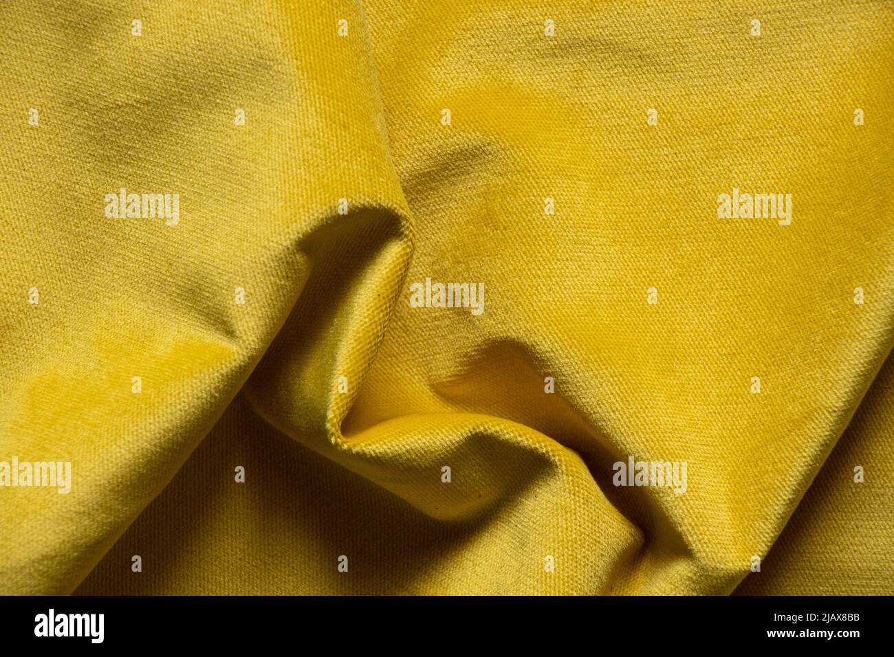 Soft velor yellow fabric as a background, backgrounds and texture, trendy blue color in support of Ukraine Stock Photo