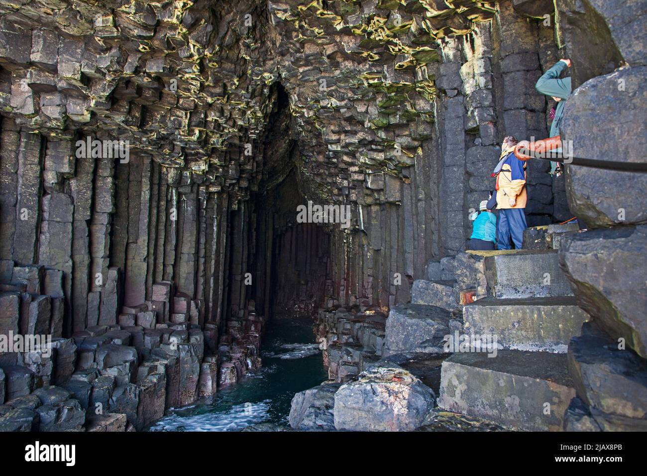 Tourists at the entrance of Fifgal's Cave on Staffa an island of the Inner Hebrides in Argyll and Bute, Scotland, UK Stock Photo