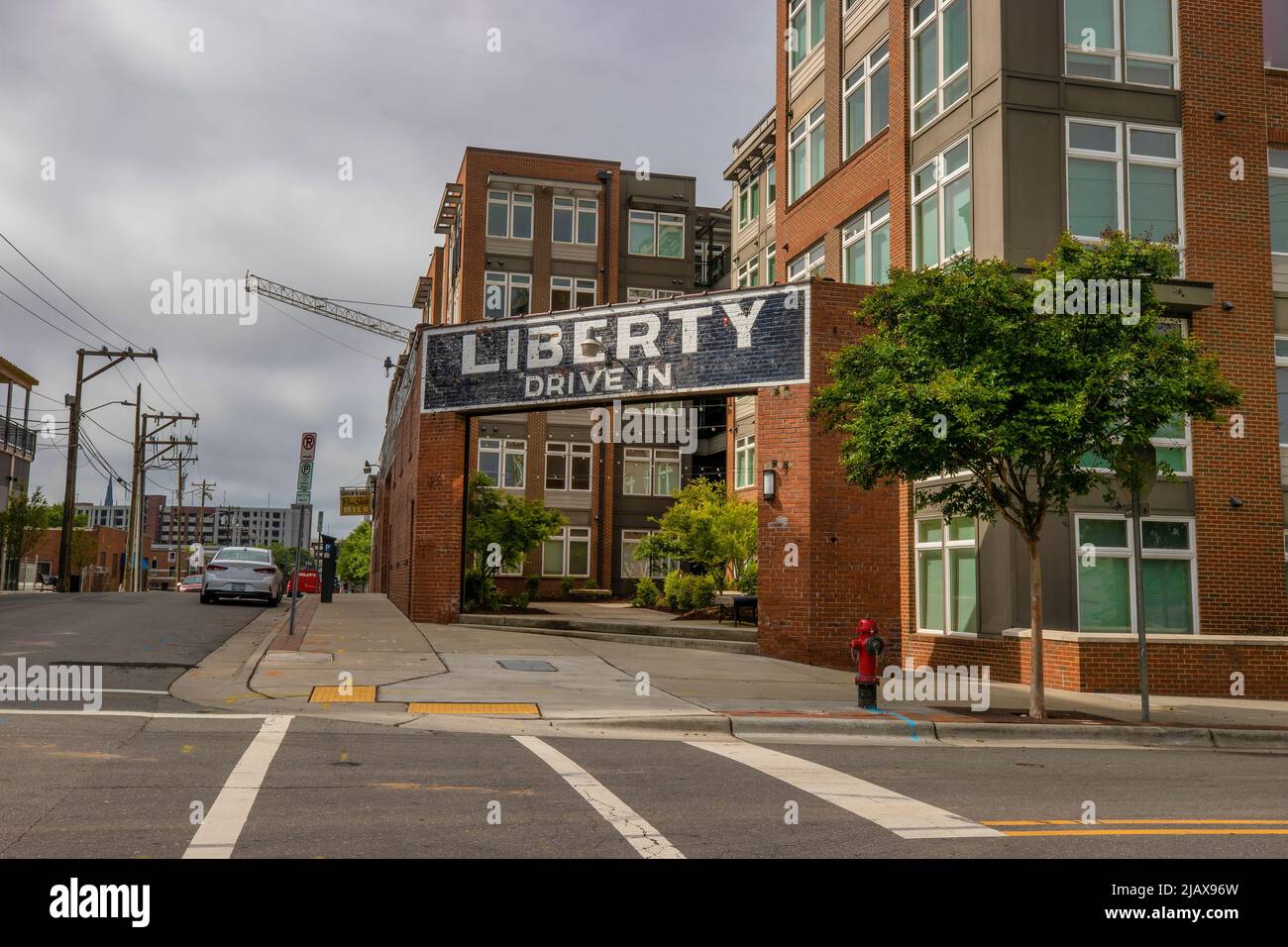 Durham, North Carolina, USA - May 2, 2022:  A courtyard  and apartment building stands where one once stood the Liberty Tobacco auction house. Stock Photo