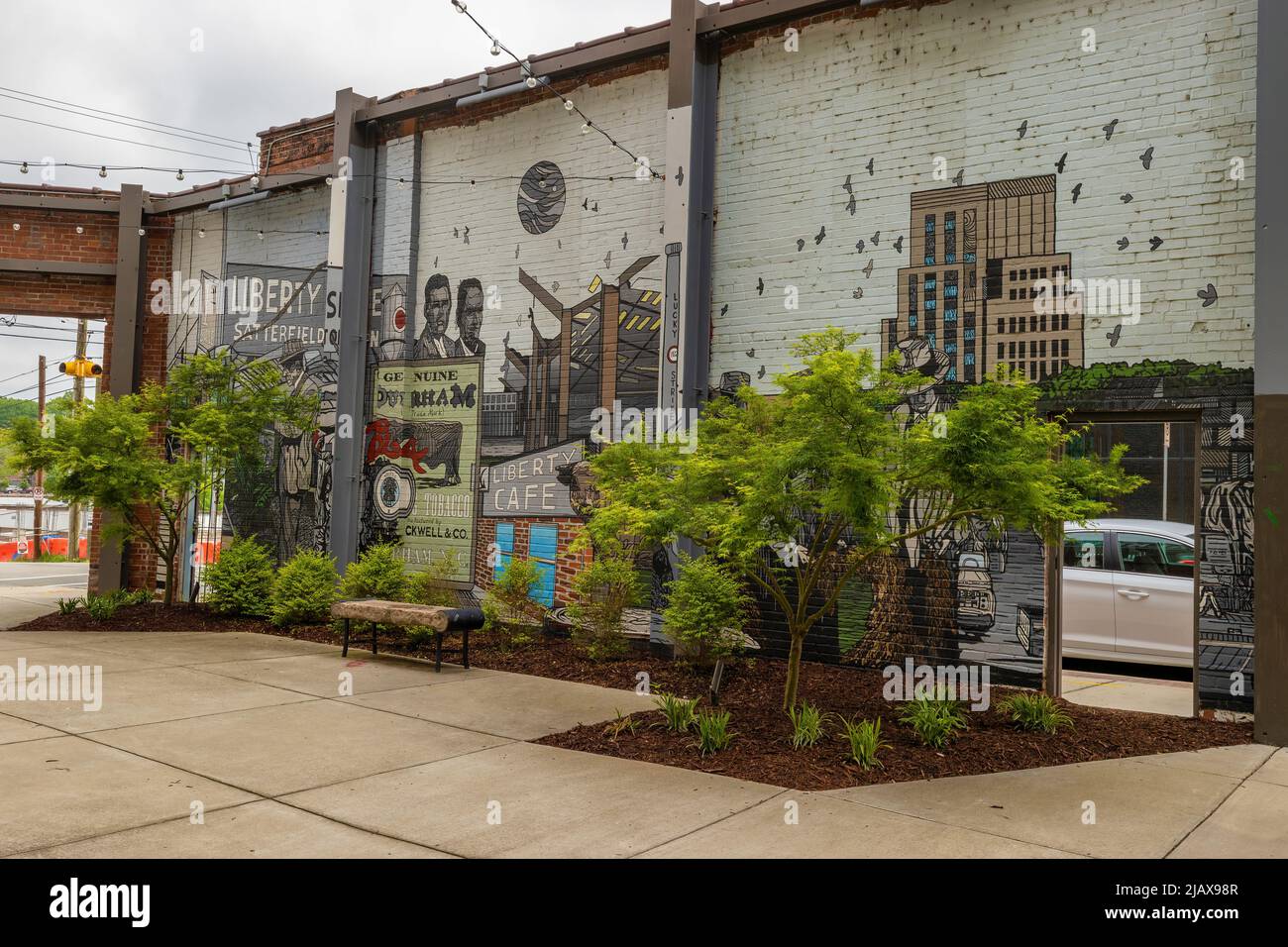 Durham, North Carolina, USA - May 2, 2022:  A courtyard  and apartment building stands where one once stood the Liberty Tobacco auction house. Stock Photo
