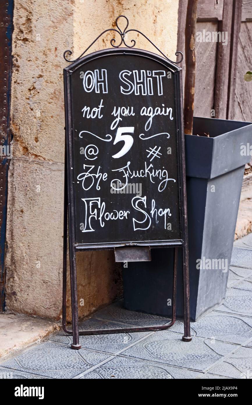 Crudely worded sign outside florist shop, Tarragona Stock Photo