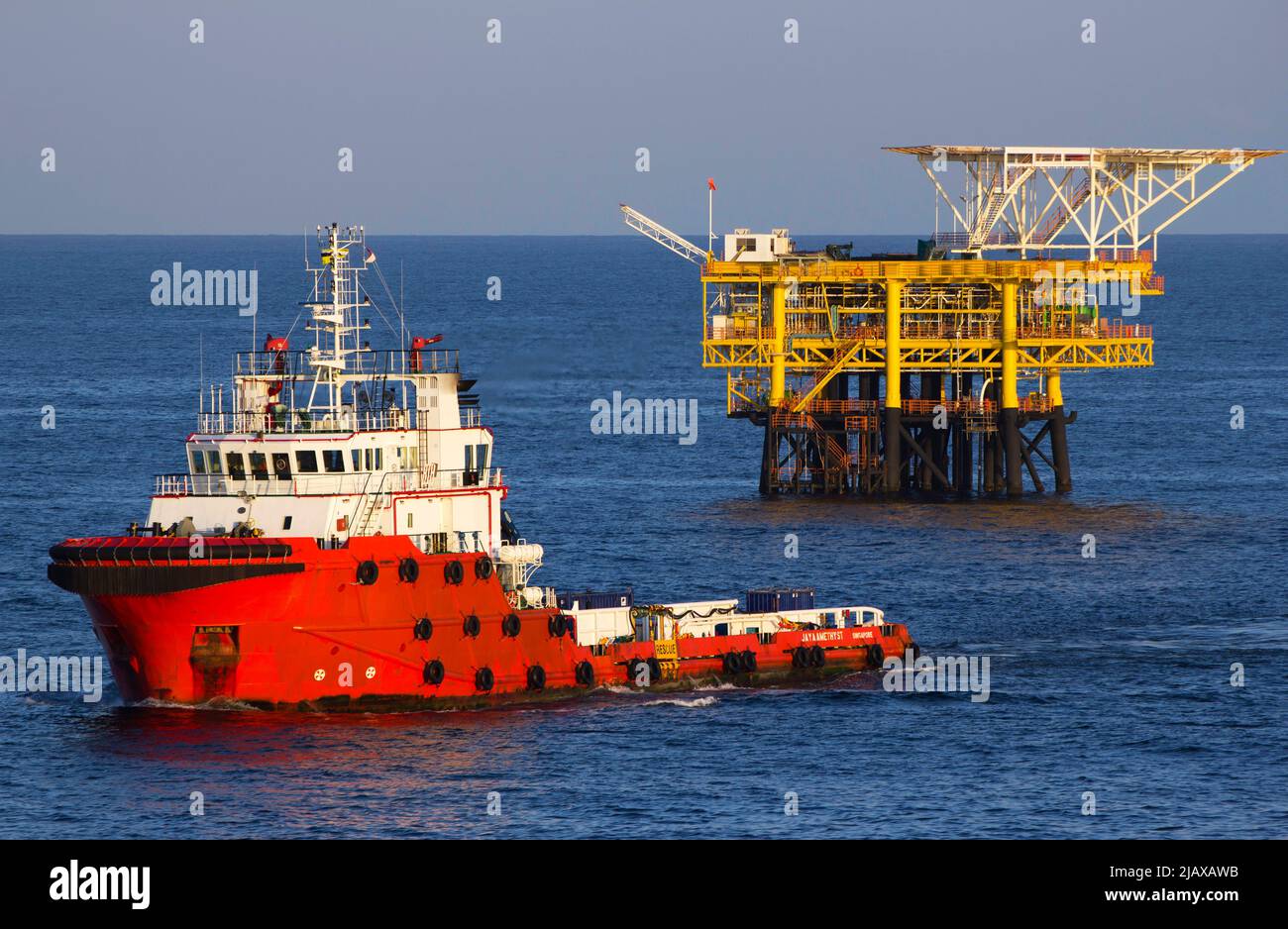 Oil rigs with supply boat boat for transporting people or materials to
