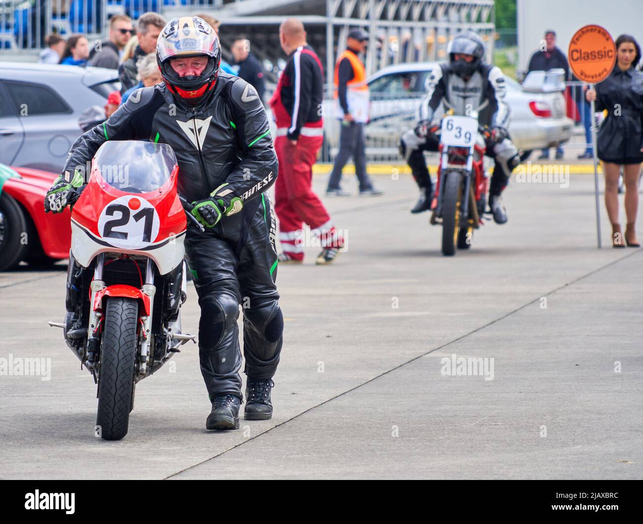 Hildesheim, Germany, May 21, 2022: Entry of motorcycles into the paddock after a race with classic cars Stock Photo