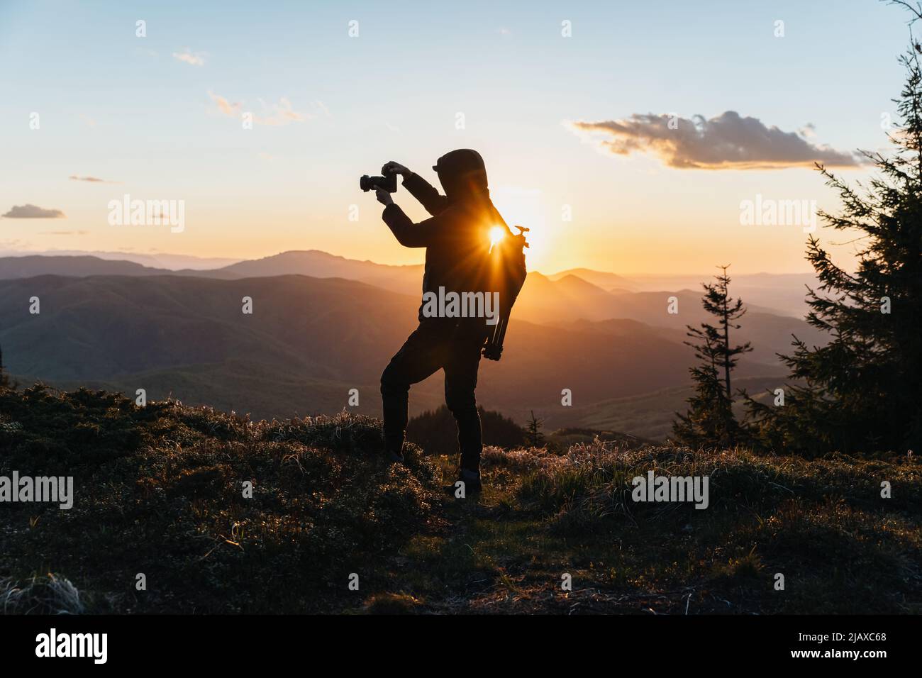 Silhouette of Man Holding Camera at Sunset on the Mountain Stock Photo ...