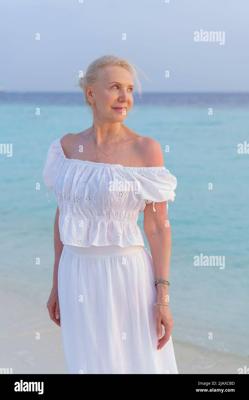 Portrait of a beautiful mature woman on the ocean. Stock Photo