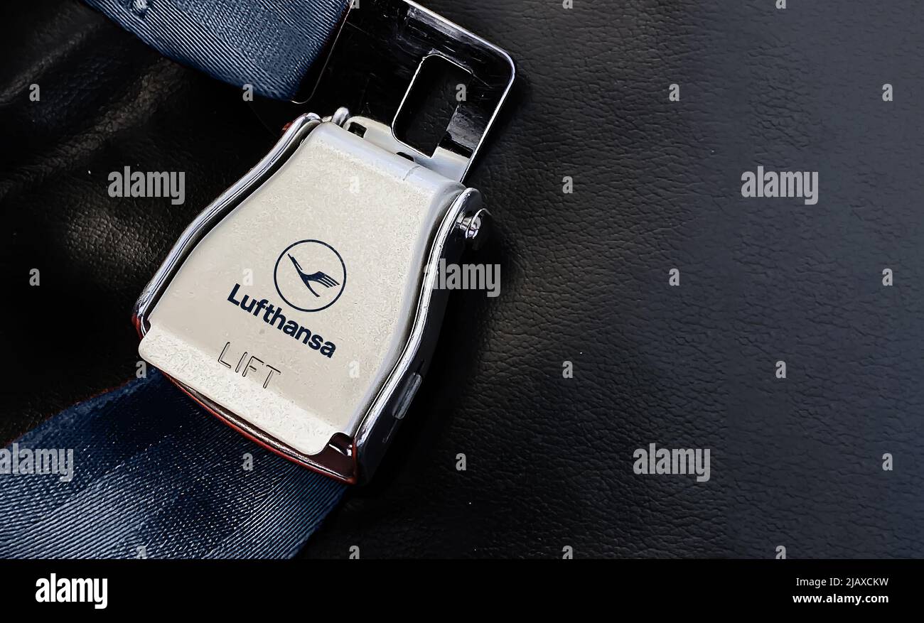 Berlin, German, May 2022: airplane passenger seat safety belt with the Lufthansa logo printed on the metal. Travel and airport security Stock Photo