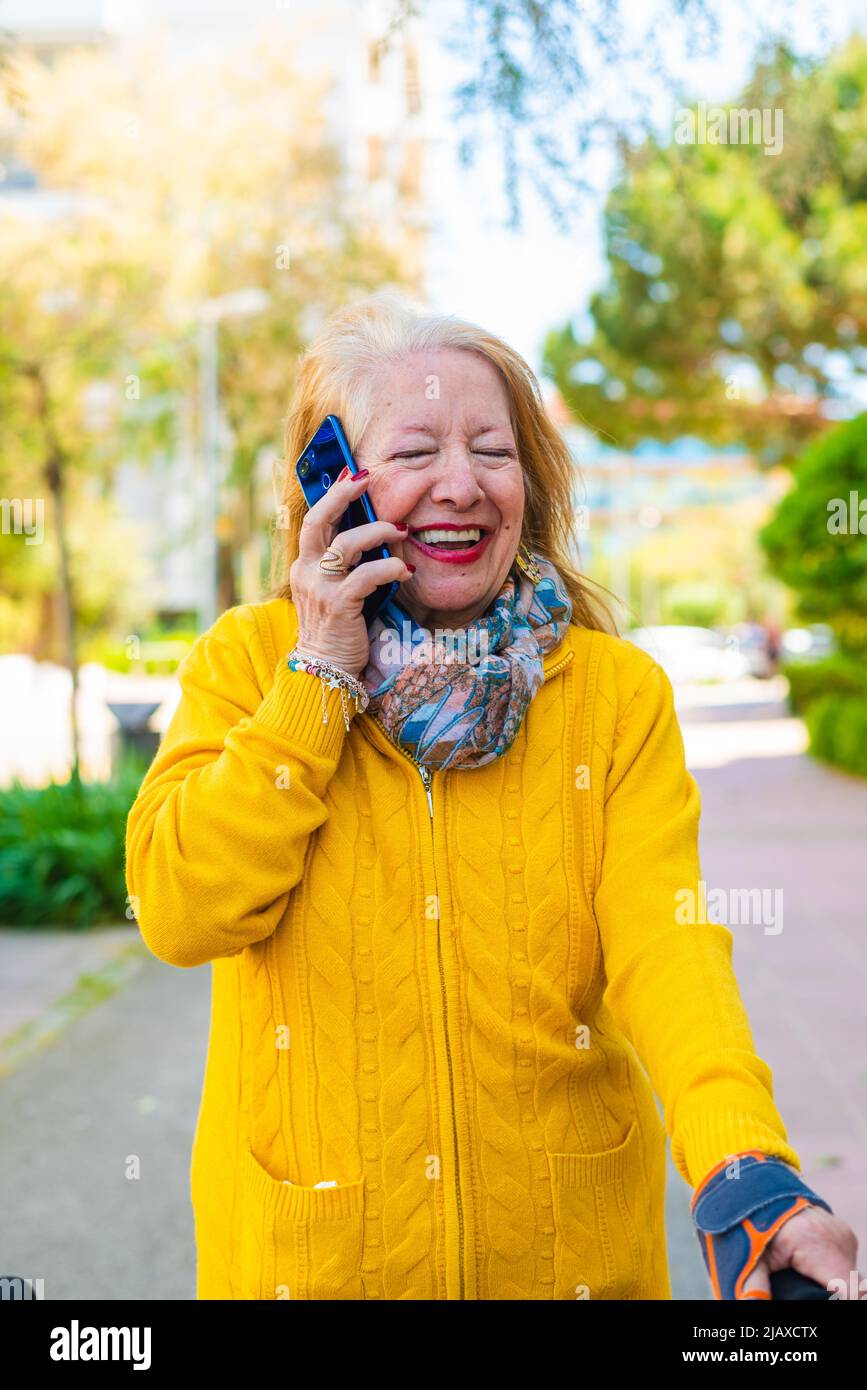 80-year-old woman using a mobile phone Stock Photo