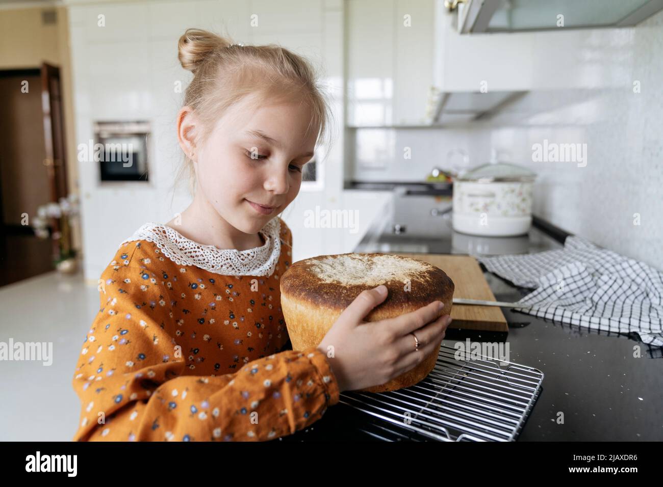 Portrait of a girl with fresh homemade bread. Stock Photo