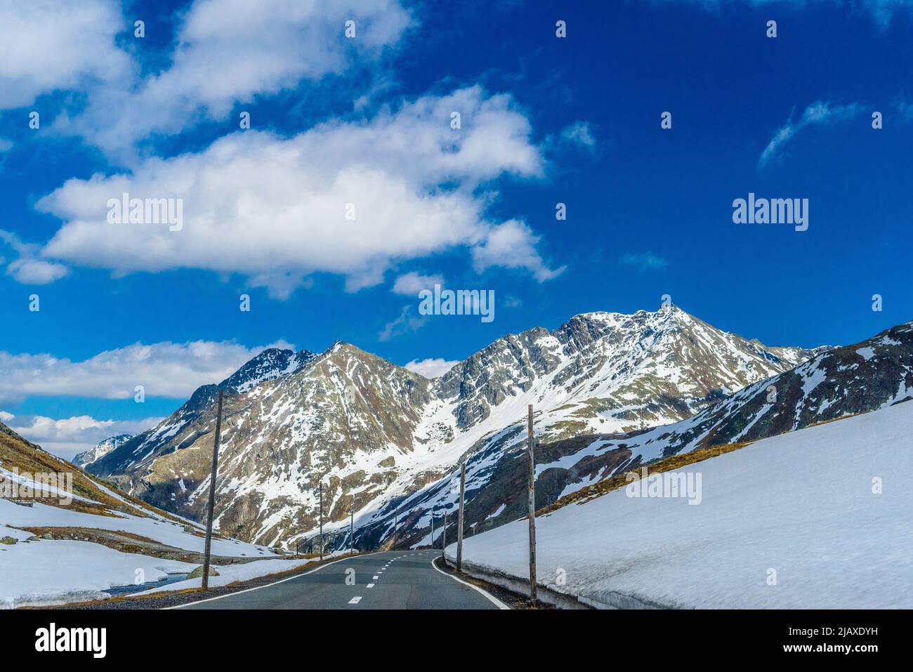 Road amoung snowy Alps mountains, Fluelapass, Davos, Graubuende Stock Photo