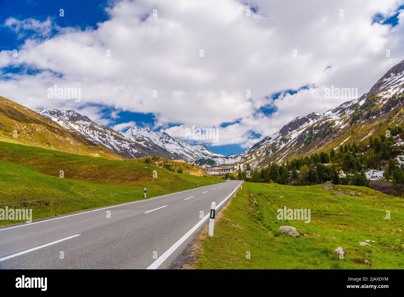 Road amoung snowy Alps mountains, Fluelapass, Davos, Graubuende Stock Photo