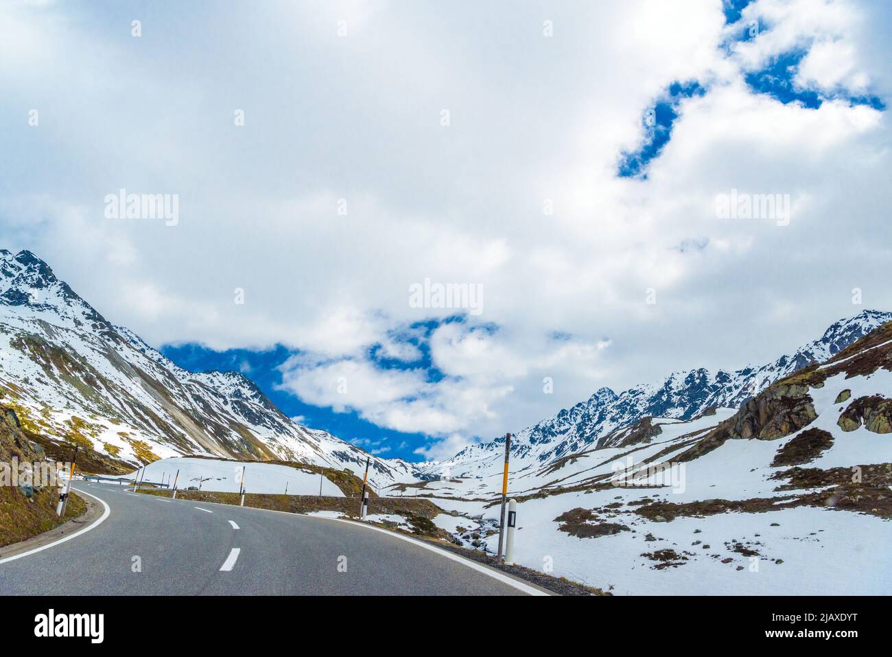 Road amoung snowy Alps mountains, Fluelapass, Davos, Graubuende Stock Photo