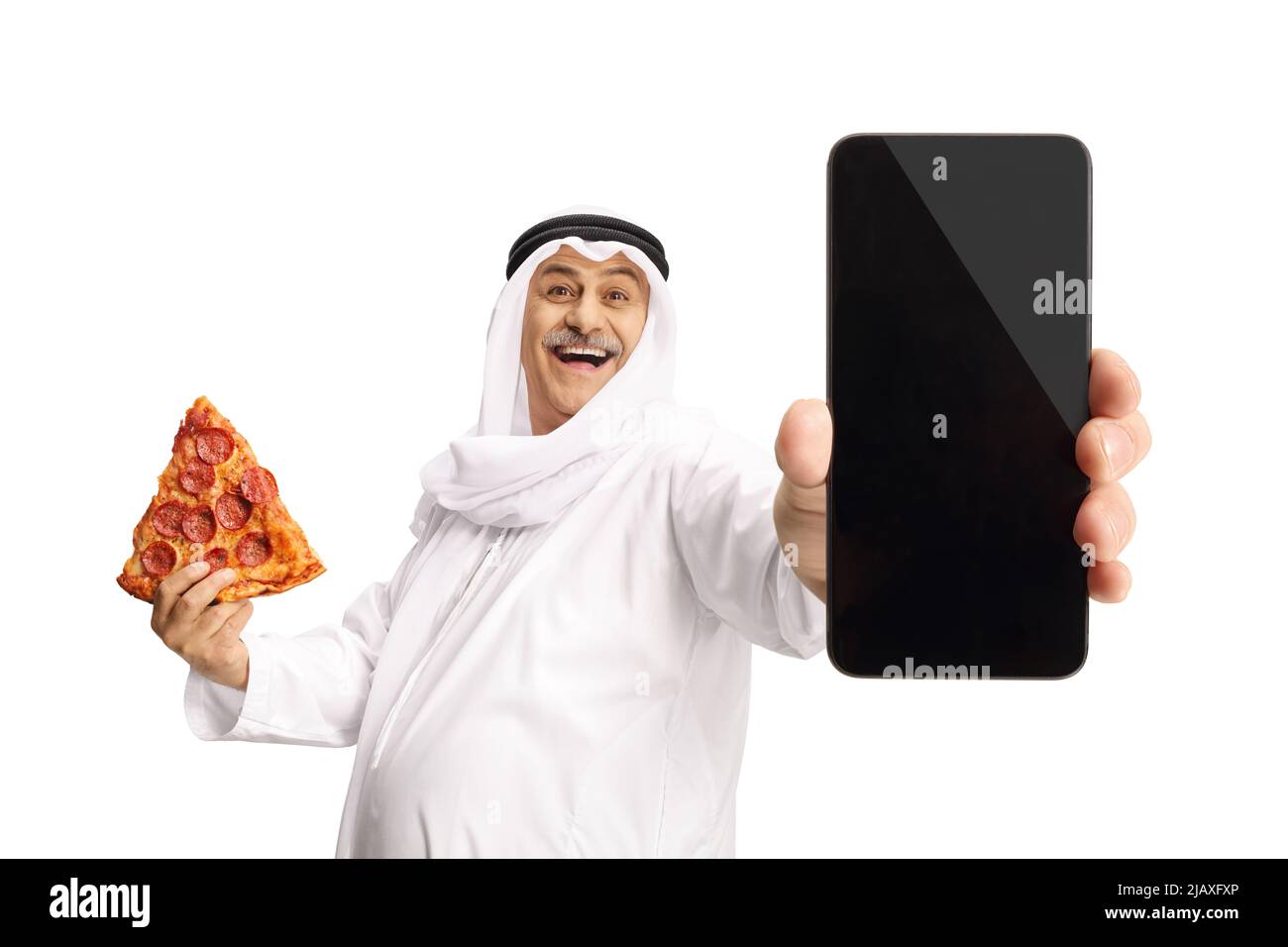 Mature arab man holding pepperoni pizza slice and showing a smartphone isolated on white background Stock Photo