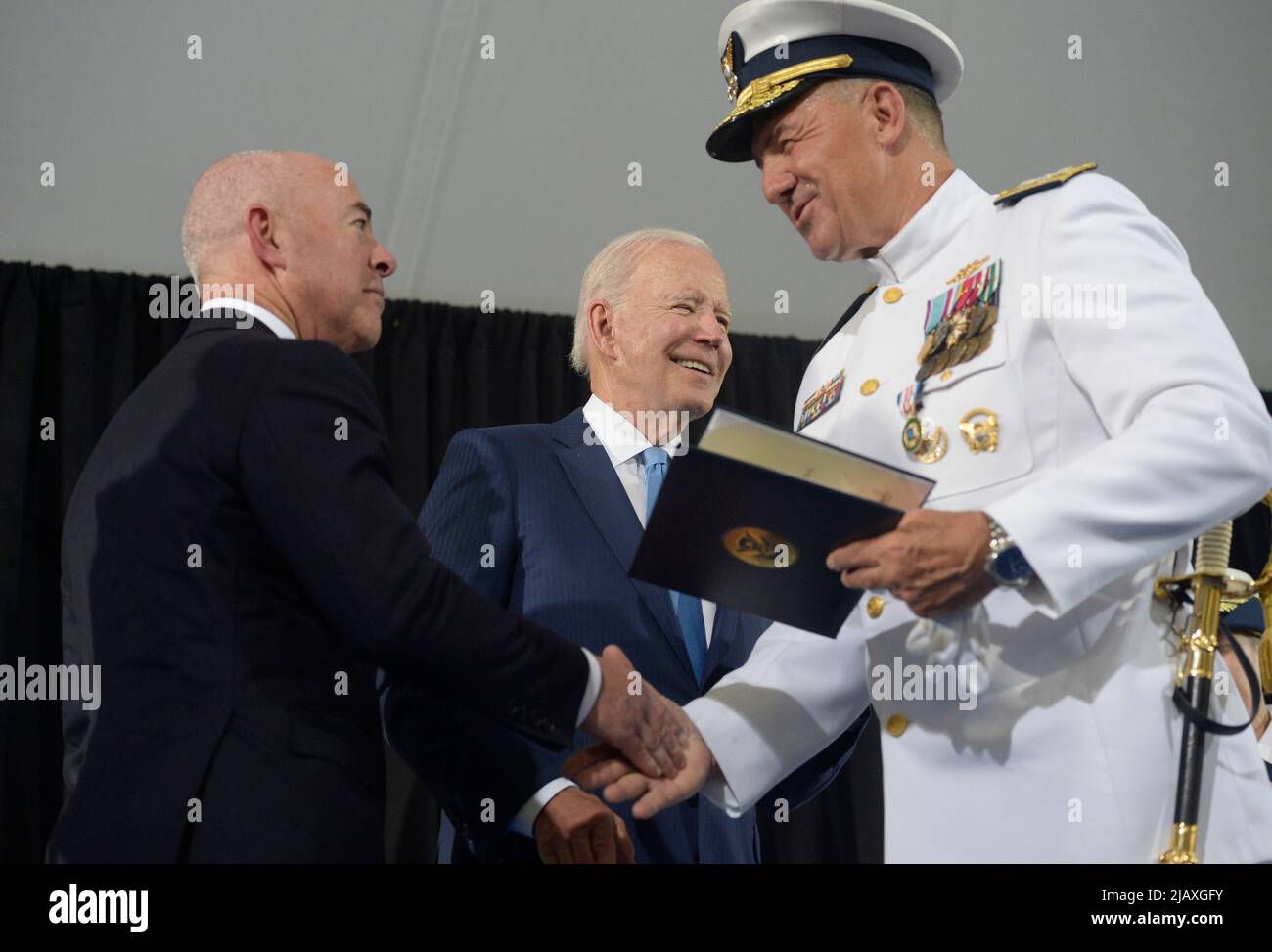 Washington, United States. 01st June, 2022. U.S. Coast Guard Adm. Karl L. Schultz shakes hand with President Joe Biden and Homeland Security Secretary Alejandro Mayorkas (L) during a change of command ceremony at Coast Guard Headquarters in Washington, DC on Wednesday, June 1, 2022. Coast Guard Adm. Linda Fagan is taking over command from Schultz. Photo by Bonnie Cash/Pool/Sipa USA Credit: Sipa USA/Alamy Live News Stock Photo