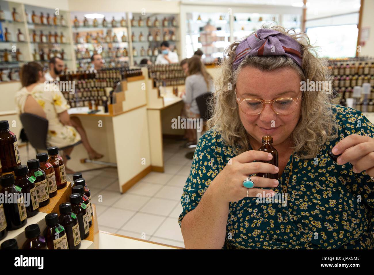Mariska Lokker, 49, a tourist from the Netherlands, creating her own fragrance during a workshop at the Galimard Studio des Fragrances in Grasse, France on September 10, 2021. Grasse has had a prospering perfume industry since the end of the 18th century and is considered the world's capital of perfume. There are numerous of old 'parfumeries' in Grasse, such as Galimard, Molinard and Fragonard, each with tours and a museum. Many 'noses' ('Les nez' in French) are trained or have spent time in Grasse to distinguish over 2,000 kinds of scent. Grasse produces over two-thirds of France's natural ar Stock Photo