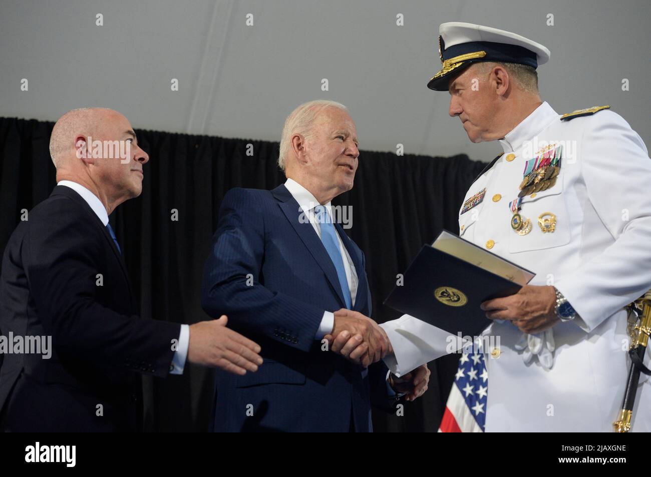 Washington, United States. 01st June, 2022. U.S. Coast Guard Adm. Karl L. Schultz shakes hand with President Joe Biden and Homeland Security Secretary Alejandro Mayorkas (L) during a change of command ceremony at Coast Guard Headquarters in Washington, DC on Wednesday, June 1, 2022. Coast Guard Adm. Linda Fagan is taking over command from Schultz. Photo by Bonnie Cash/Pool/Sipa USA Credit: Sipa USA/Alamy Live News Stock Photo