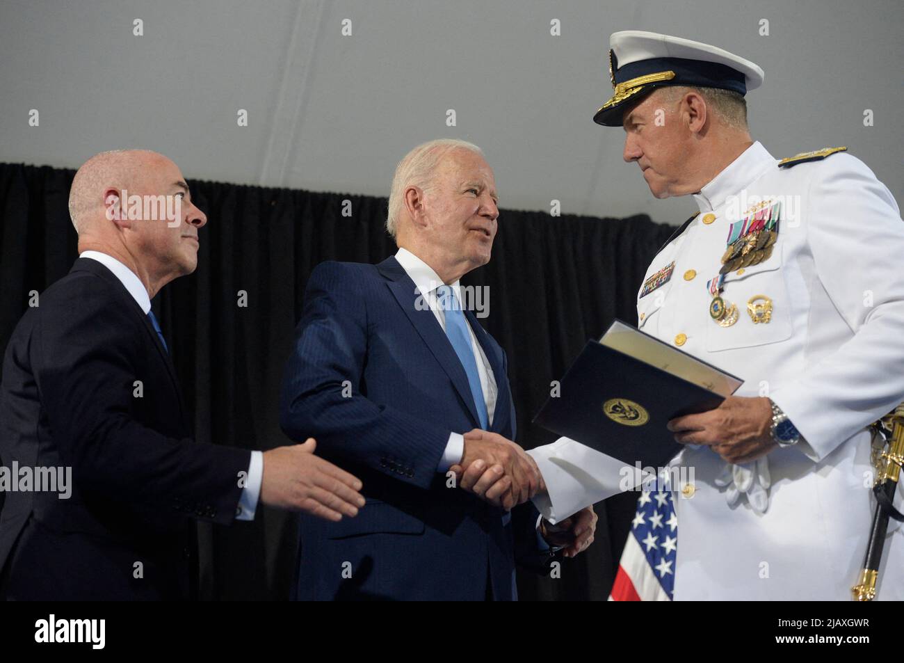 U.S. Coast Guard Adm. Karl L. Schultz shakes hand with President Joe Biden and Homeland Security Secretary Alejandro Mayorkas (L) during a change of command ceremony at Coast Guard Headquarters in Washington, DC on Wednesday, June 1, 2022. Coast Guard Adm. Linda Fagan is taking over command from Schultz. Photo by Bonnie Cash/Pool/ABACAPRESS.COM Stock Photo
