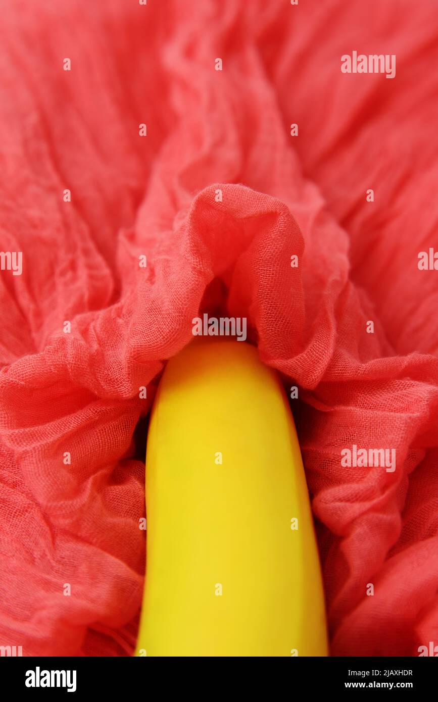 Sexy concept with banana on pink textile. Selective focus Stock Photo