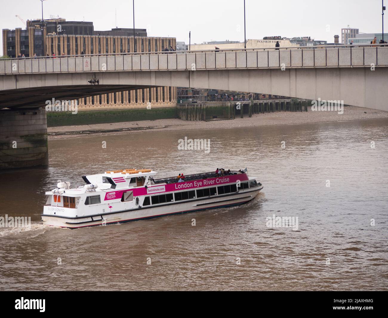 Tourists aboard the London Eye River cruise ferry, Silver Bonito, motors down the River Thames Stock Photo