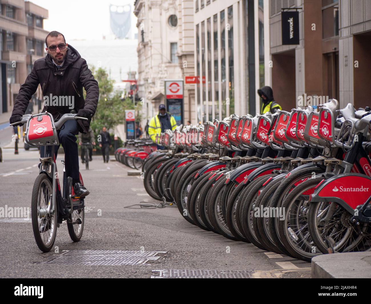 Rows of Santander rental bikes for hire in Central London Stock Photo