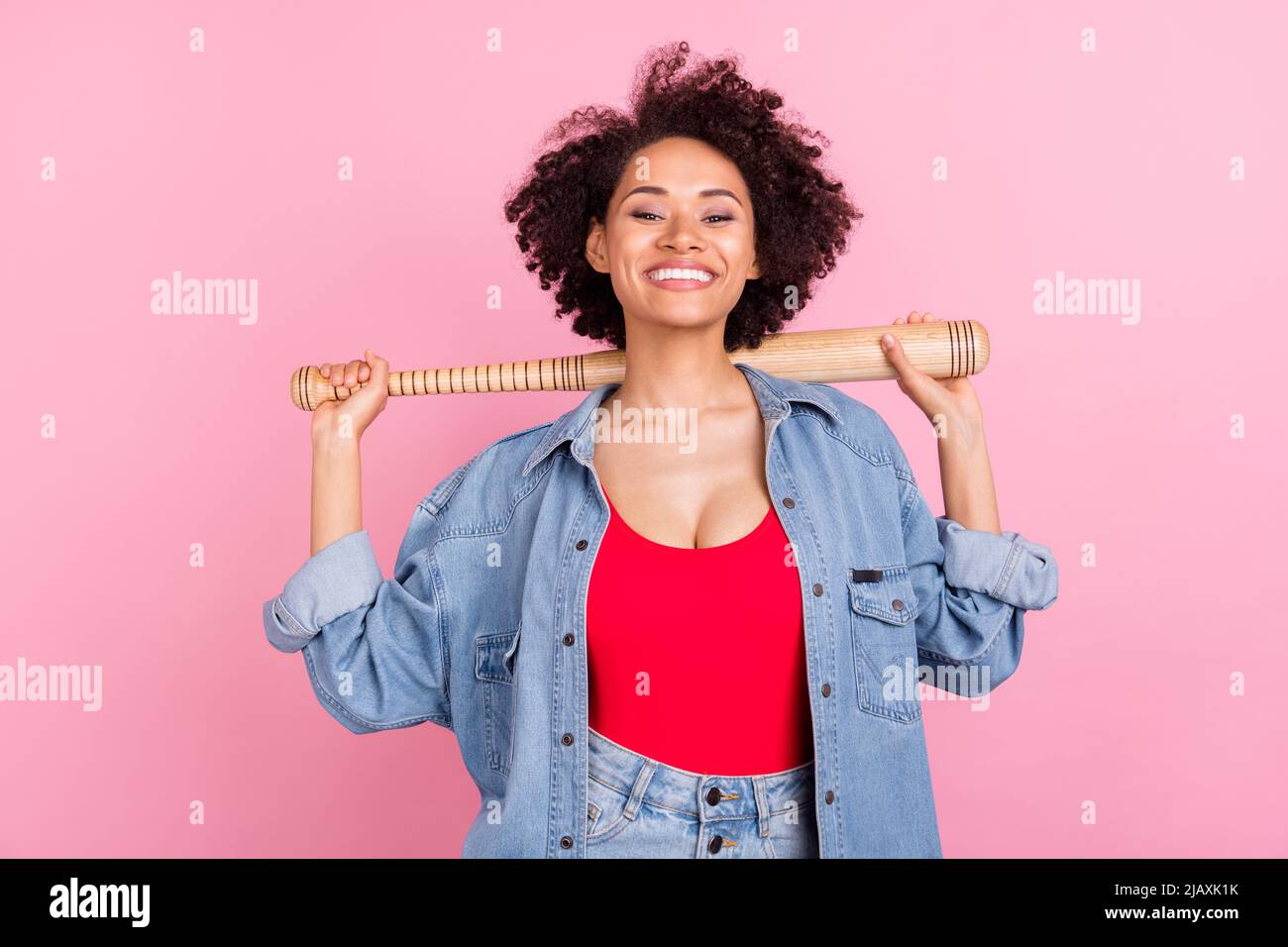 Photo of young cheerful happy afro american woman hold hands baseball bat isolate on pink color background Stock Photo