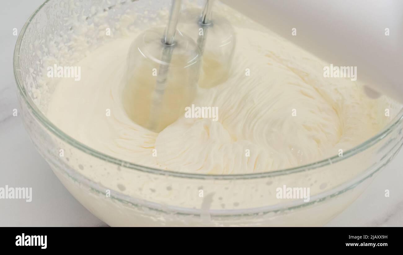 Whipped cream cheese desert recipe. Mixing ingredients in a glass bowl