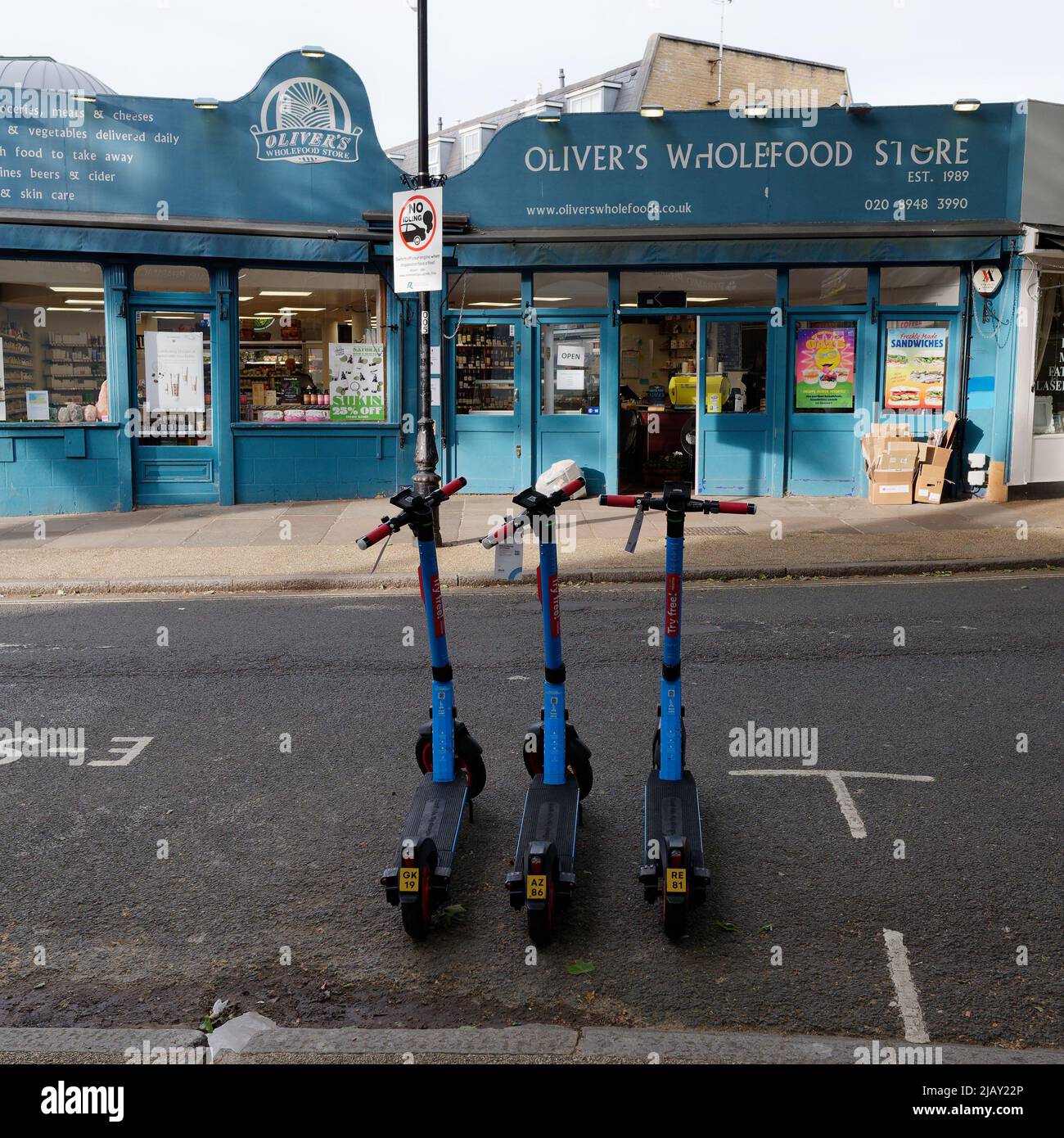 Kew, Greater London, England, May 18 2022: Try Free escooters outside Oliver's Wholefood Store. Stock Photo