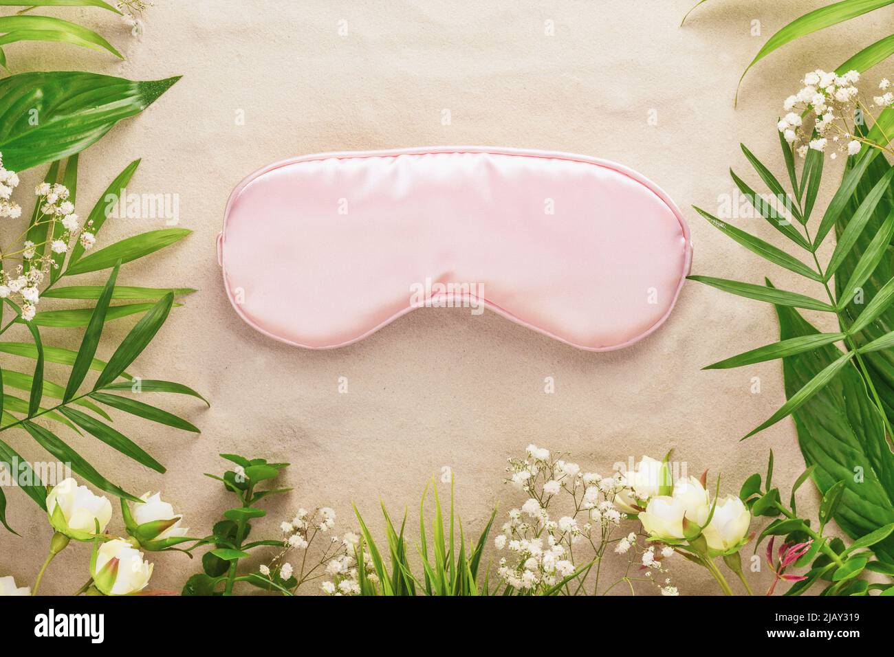 Relax card with pink mask for sleep, tropic plant and flowers Stock Photo