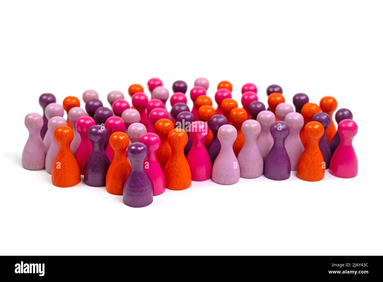 Many colorful wooden skittles, symbolic of people, in front of a white background Stock Photo