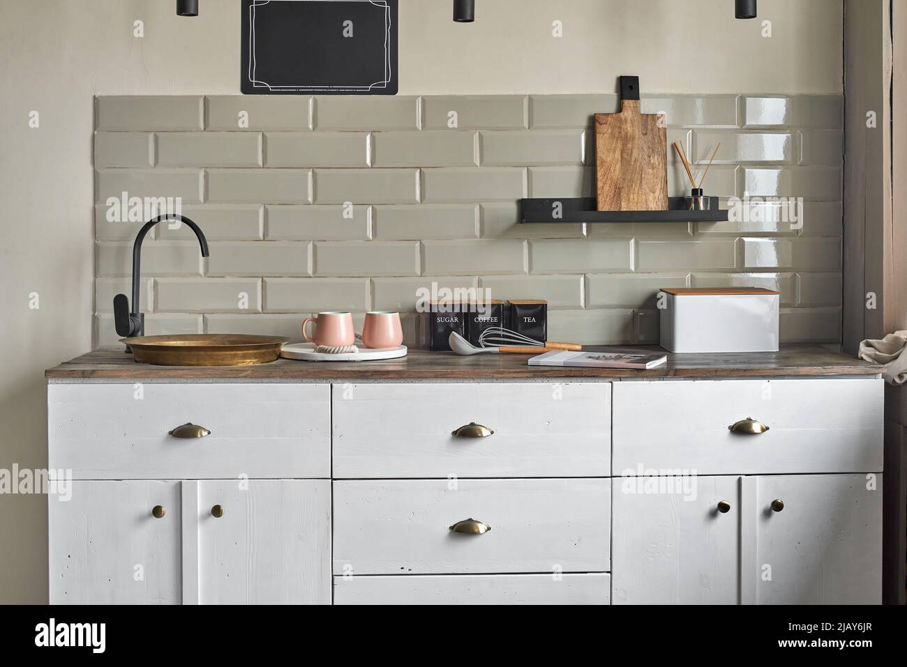 Elegant small kitchen with sink and counter at country house. Stock Photo