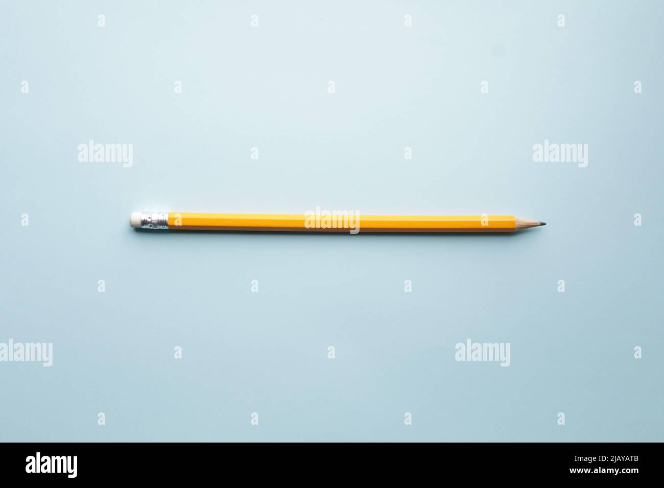 Yellow pencil on blue background, learning concept Stock Photo