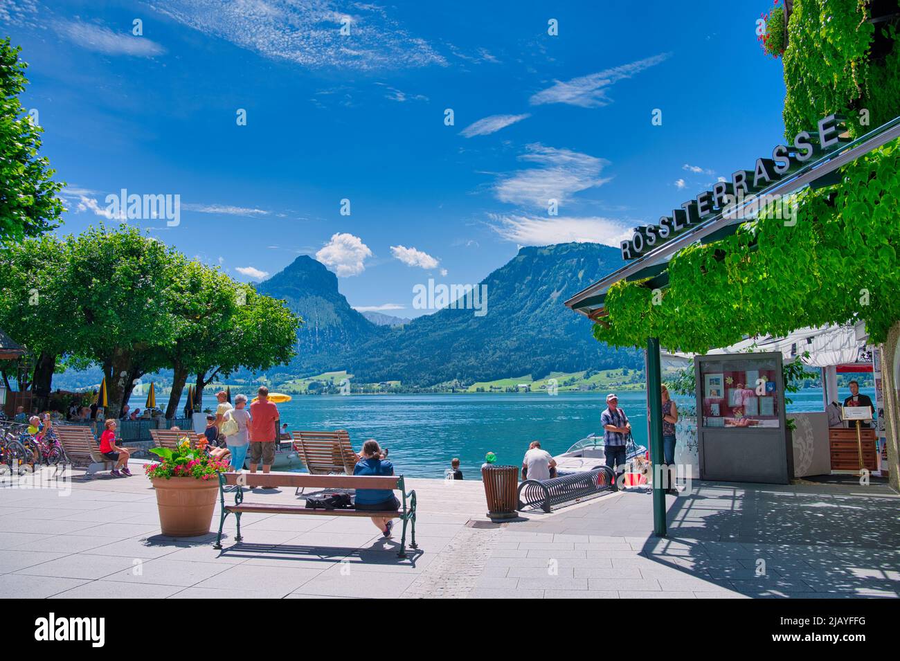 St. Wolfgang, Austria - July 09,2020 People At The Lake Wolfgang With View To The Famous Terrace Of The Legendary White Horse Inn Weisses Roessl Stock Photo