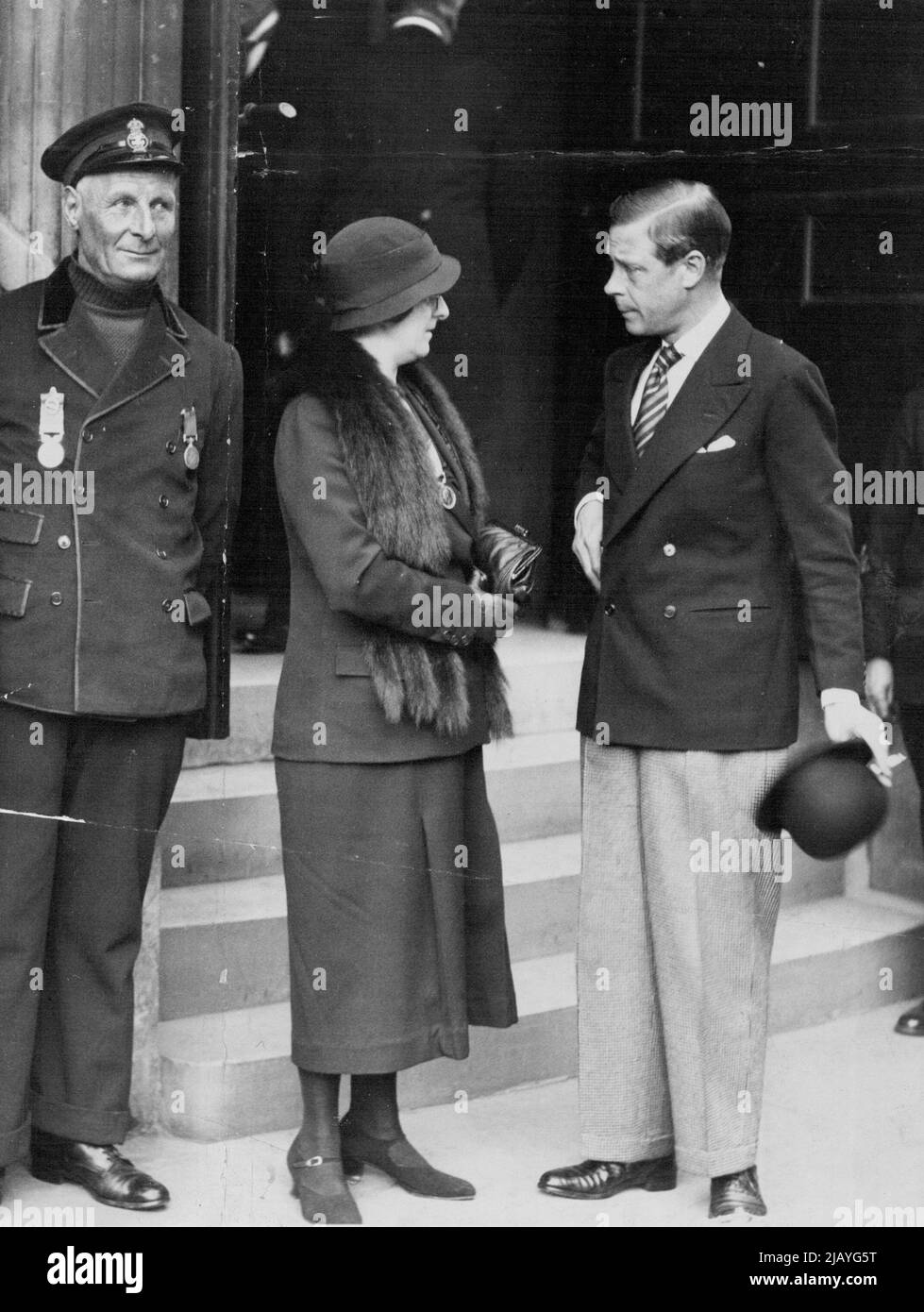 The Prince of Wales chatting to Mrs. Robert Patton, after he had presented her with her husband's V.C. on left is Coxswain Henry Blogg, of Cromer, who received a bar to his silver medal. H.R.H. the Prince of Wales presented the awards at the Annual Meeting of the Royal National Lifeboat Institution, held at the Caxton Hall, Victoria-street, this afternoon. April 20, 1934. Stock Photo