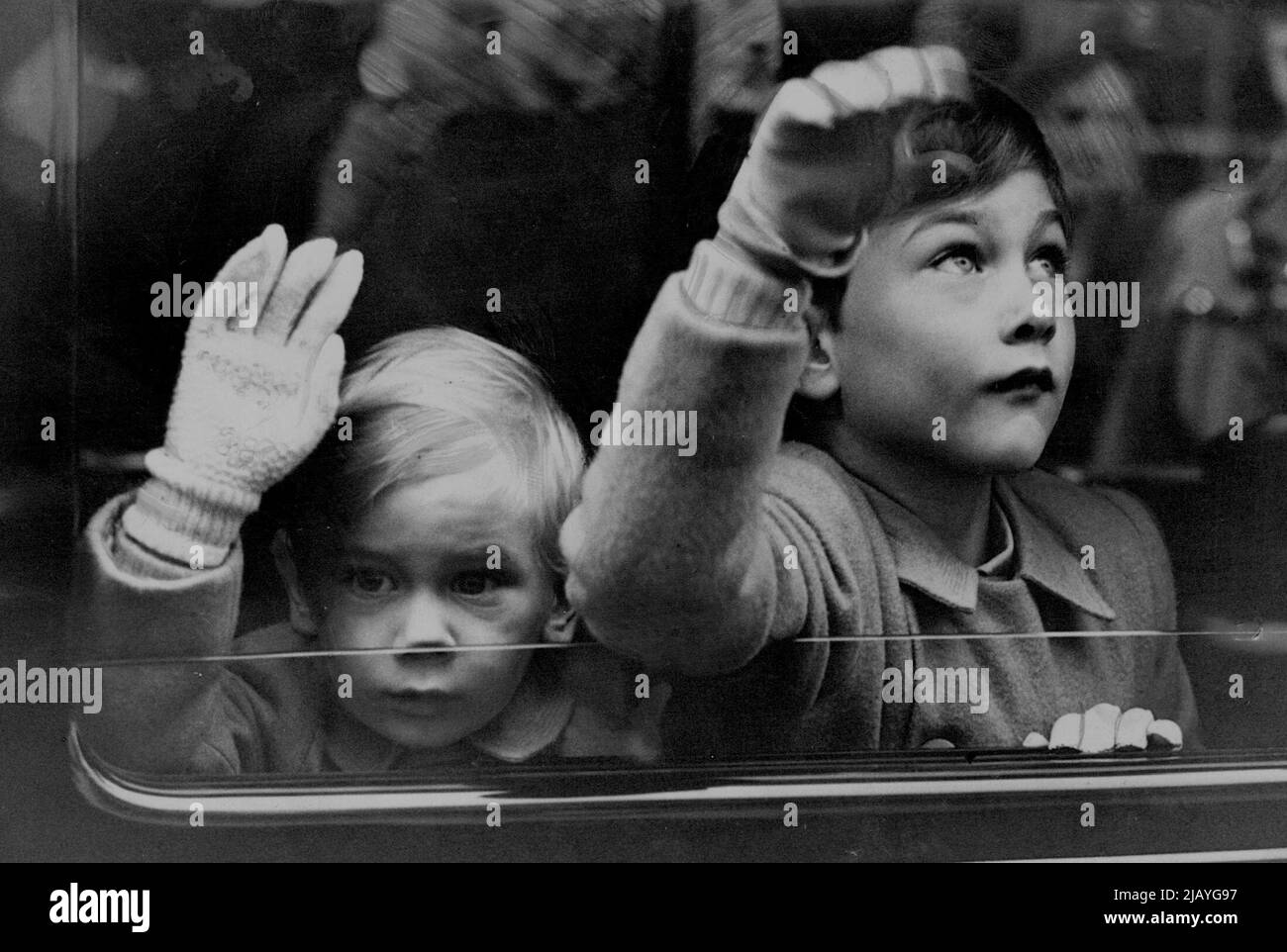 Duchess of Gloucester Home From Australia With The Children -- Prince William (right) and Prince Richard wave from a window of the car as they left Tilbury for London. The Duchess of Gloucester and her two sons - Prince William, aged 5, and Prince Richard, aged 2½ - landed from the liner 'Rangitiki' at Tilbury, Essex, on their return home from Australia. The Duke, who recently relinquished the Governor-Generalship of Australia, had flown home previously to act as a Councillor of State during King George's absence in South Africa. March 20, 1947. Stock Photo