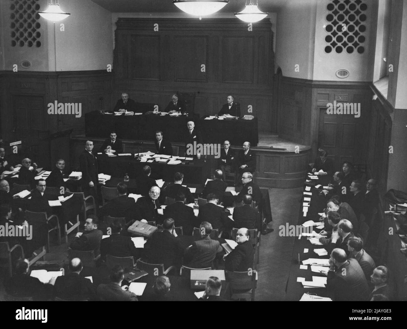 Bribes Inquiry Opens - A general view of the scene in the Hoare Memorial Hall, Church House, Westminster, this morning, November 15, as the judicial inquiry into alleger irregularities in Government departments re-opened. President of the Inquiry, Mr. Justice Lynskey is seen, centre, on the presidential bench, with Mr. Russell Vick, K.C. (left) and Mr. Gerald Upjohn (right), comprising the tribunal. Standing in well of Chamber, at left, facing camera, is the Attorney General, Sir Hartley Shawcross. November 15, 1948. (Photo by Associated Press Photo). Stock Photo