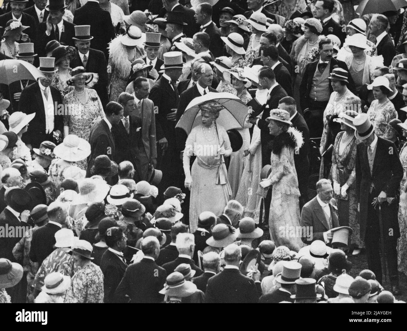 The Royal Garden Party -- Their Majesties the King and Queen gave a garden party at Buckingham Palace today, July 20th., for which more than 6000 invitations had been sent out. A general view showing T.M. The King and Queen among their guests. On the right of the Queen may be seen The Prince of Wales, the Duke of Gloucester and Prince George. August 28, 1933. (Photo by Sport & General Press Agency, Limited). Stock Photo