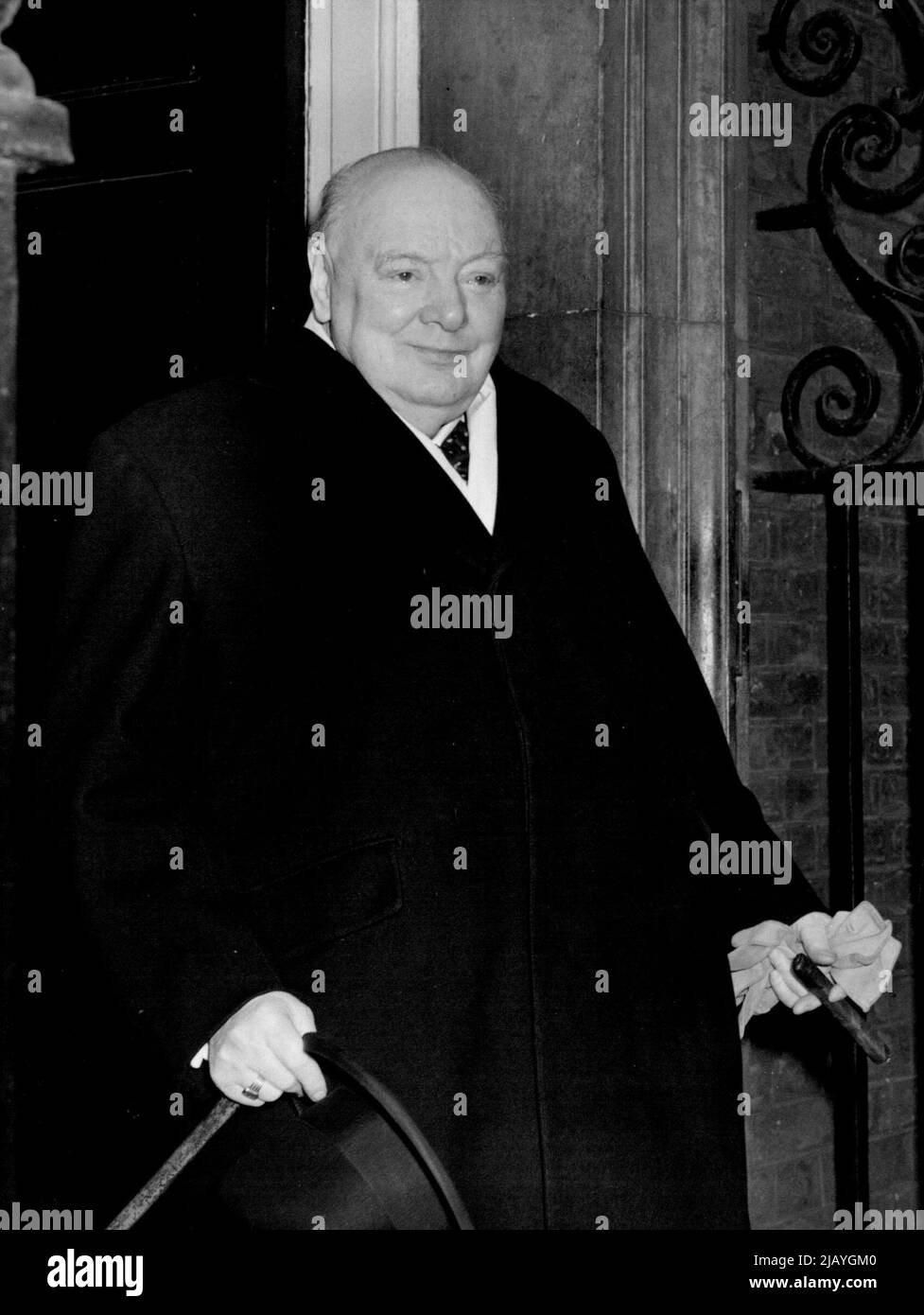 Premier Fit and Well Again -- Looking fighting fit and completely recover from his cold Sir Winston Churchill is seen leaving No.10, Downing Street this afternoon.  Sir Winston Churchill who has been suffering from a cold which has kept him indoors for the past few days, has now completely recovered and looked fit and well went he left No.10, Downing Street for the House this afternoon, after Mrs. Roosevelt had lunched with him. March 10, 1955. (Photo by Fox Photos). Stock Photo