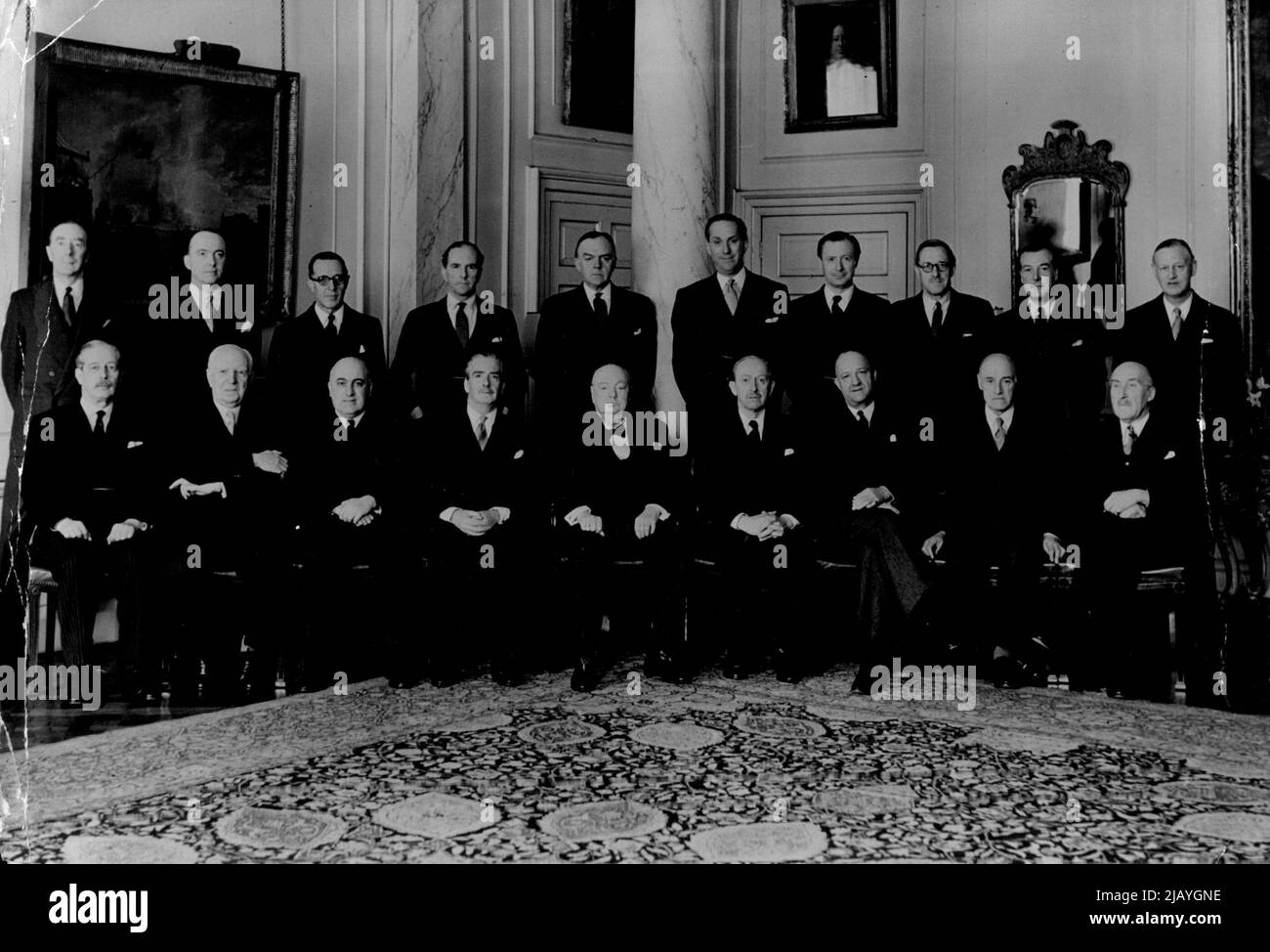 Sir Winston with his Cabinet -- (Left to right - Back row) Mr.Osbert Peake, Mr.Peter Thorneycroft, Sir Walter Monkton, Mr.Stuart, Mr.Lloyd George, Mr.Lennox-Boyd, Mr.Duncan Sandys, Sir Norman Brook (Secretary to the Cabinet), (front row) Mr. MacMillan, Lord Woolton, Lord Kilmuir, Sir Anthony Eden, Sir Winston Churchill, Lord Salisbury, Mr. Butler, Lord Swinton and Mr. Crookshank. Sir Winston Churchill Photographed at No.10. Downing street after this morning's Cabinet Meeting. April 05, 1955. (Photo by Paul Popper, Paul Popper Ltd.). Stock Photo